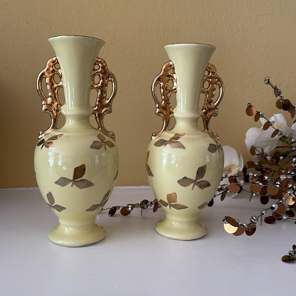 Two matching Vintage Le Pere Pottery yellow bud vases with gold luster details.